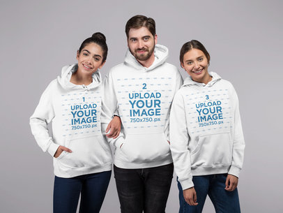 Mockup of a Group of Friends Wearing Hoodies in a Studio