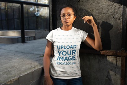 T-Shirt Mockup of a Woman with Glasses in an Urban Environment