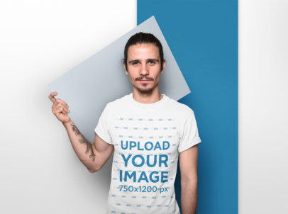 T-Shirt Mockup of a Man Holding a Pasteboard Behind his Back 18529