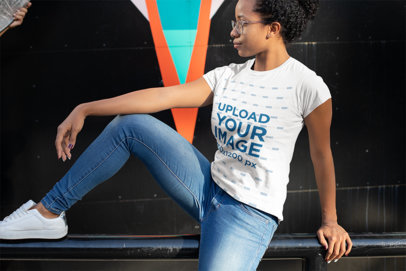Tee Mockup of a Woman Wearing Jeans in an Urban Scenario