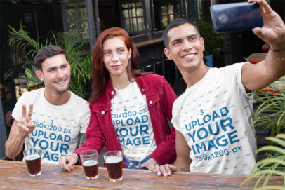 T-Shirt Mockup of Three Friends Taking a Selfie at a Bar