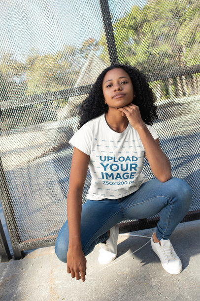 Tshirt Mockup of a Woman with Curly Hair Crouching