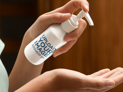 Bottle Mockup Featuring a Woman Applying Moisturizing Cream on her Hands 7154