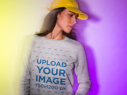 Mockup of a Woman Wearing a Heather Sweatshirt and a Hat