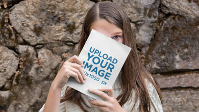 Parallax Mockup Video of a Girl Hiding Behind a Book