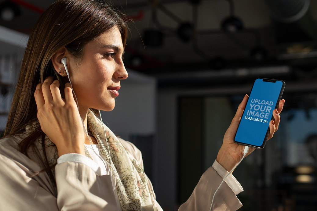 iPhone 11 Pro Max Mockup Featuring a Young Woman Listening to a Podcast