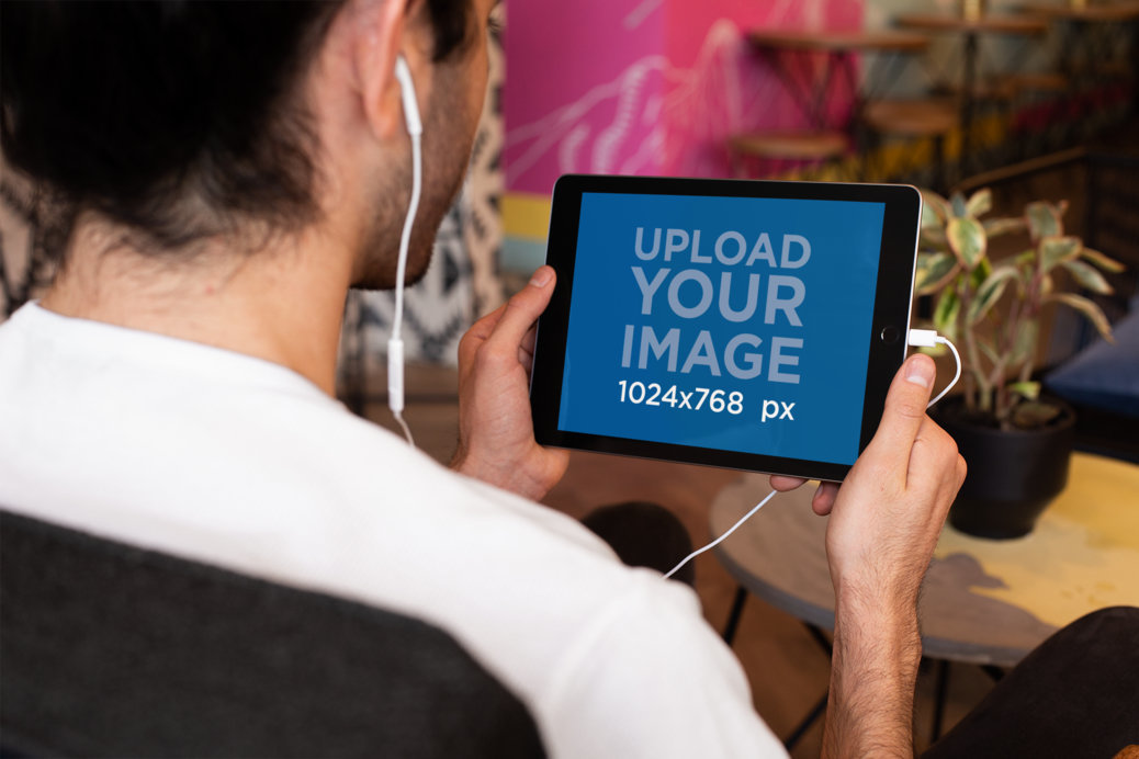 Landscape iPad Mockup of a Man Listening to a Podcast