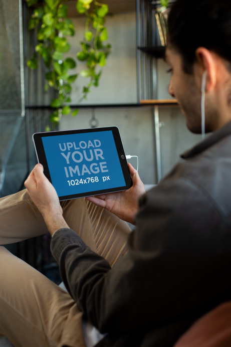 Mockup of a Man Listening to a Podcast on an iPad 6