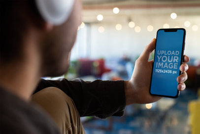 iPhone 11 Pro Mockup of a Man Listening to Music