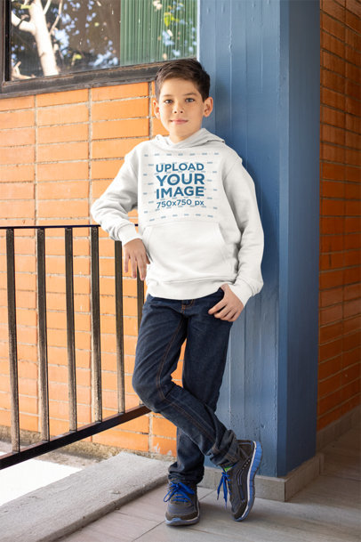 Hoodie Mockup of a Kid Leaning on a Fence at School