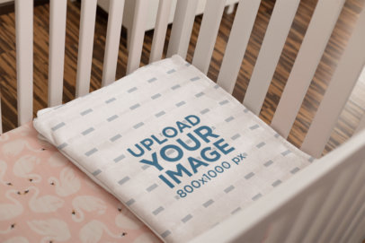 Mockup of a Folded Throw Blanket on a Girl's Cradle