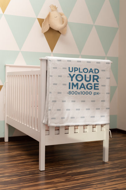 Blanket Mockup Featuring a Baby Crib in a Nursery 