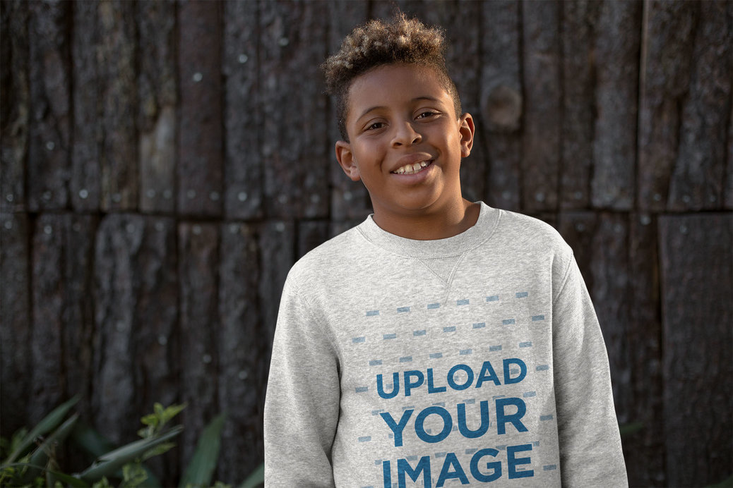 Heather Mockup of a Young Boy Wearing a Sweater Outside