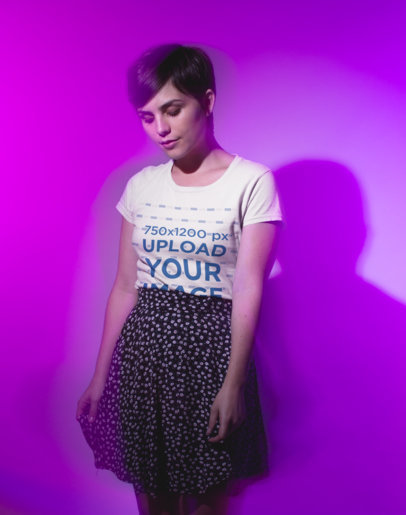 Round Neck Tee Mockup of a Woman with Short Hair Against a Purple Wall