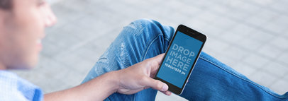 iPhone Mockup of a Young Man Sitting on a Bench at a Park a5635
