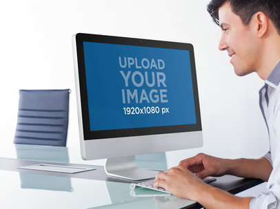 iMac Mockup of a Man Working in an Office Meeting Room