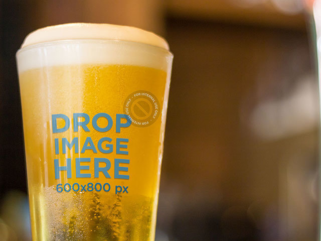 Label Mockup Featuring a Beer Glass at a Table