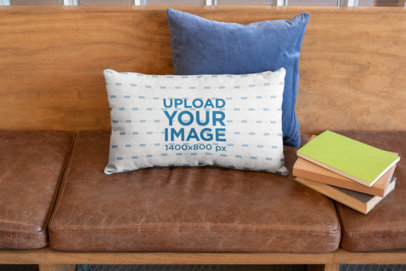Pillow Mockup Featuring Books over a Wooden Sofa with Leather Cushions