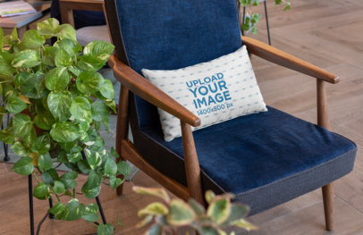 Mockup of a Pillow on an Elegant Wooden Chair 