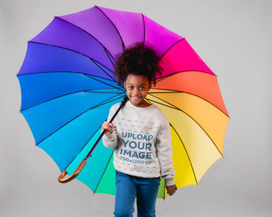 Sweatshirt Mockup of a Little Girl Holding a Rainbow Umbrella