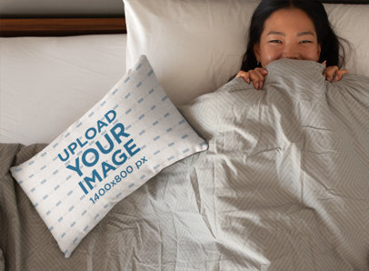 Throw Pillow Mockup with a Woman Smiling Behind a Blanket