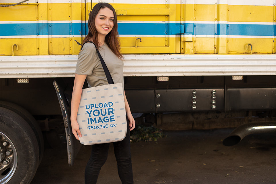 Tote Bag Mockup of a Woman Passing by a Parked Truck