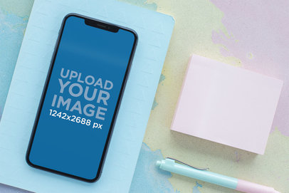 Mockup of an iPhone XS Lying Surrounded by Pastel Colored Items 25370