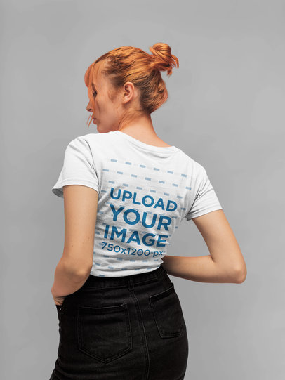 Back T-Shirt Mockup of a Red Haired Woman with a Hair Bun Standing in a Studio 