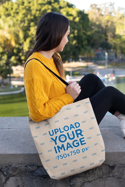 Tote Bag Mockup of a Girl Sitting at a Park 24883