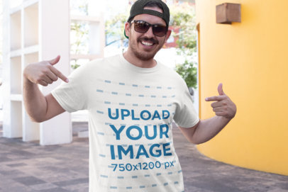 T-Shirt Mockup of a Happy Young Man with a Cap and Sunglasses