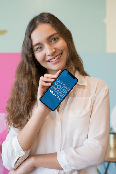 Mockup of a Smiling Woman Showing an iPhone 11 Pro