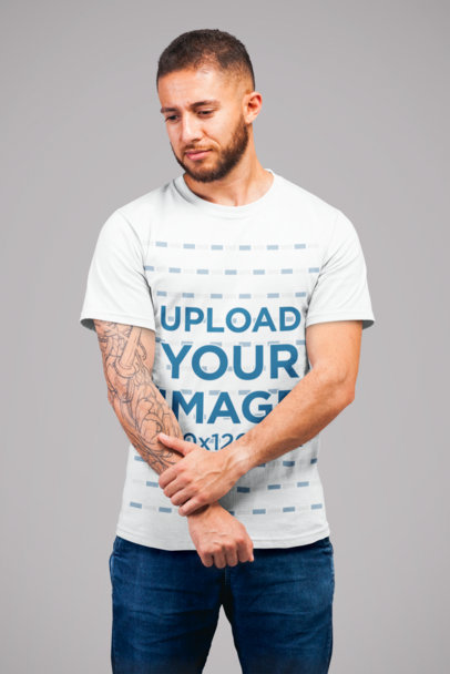 T-Shirt Mockup Featuring a Redhead Man Standing Thoughtful at a Studio