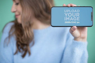 Mockup of an iPhone 11 Pro Max Being Held by a Woman
