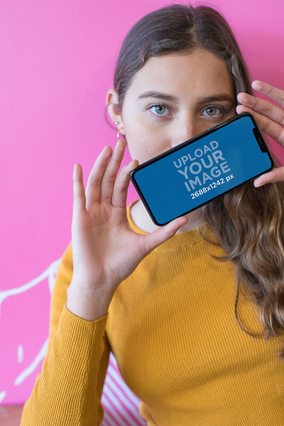 Mockup of a Woman Holding an iPhone 11 Pro Max in Landscape Position