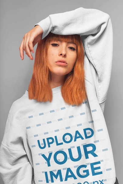 Sweatshirt Mockup of a Red-Haired Woman with an Arm over Her Head