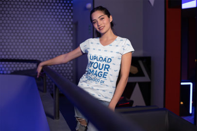 T-Shirt Mockup of a Woman Posing in an Arcade Place