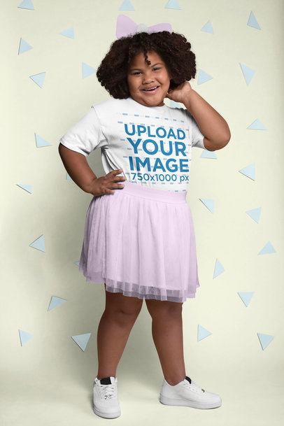 Tee Mockup of a Joyful Girl with Curly Hair Surrounded by Cut out Paper Shapes