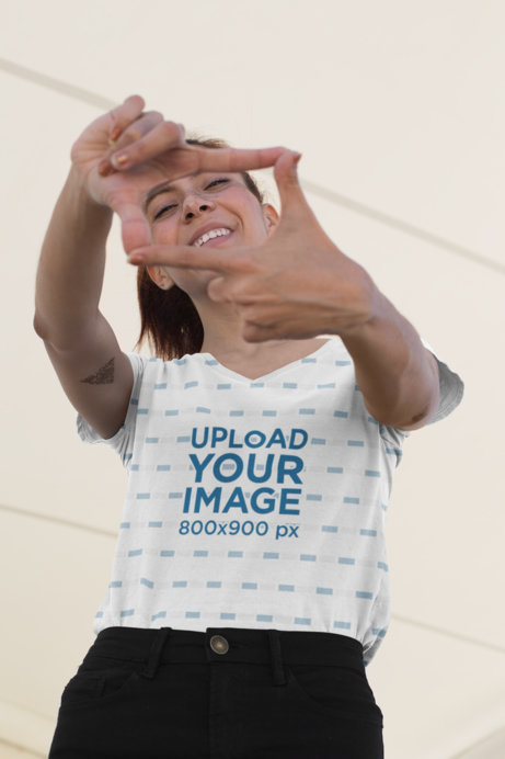 Sublimated V-Neck Tee Mockup of a Woman Framing Her Face with Her Fingers