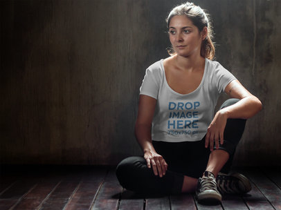 Sports T-Shirt Mockup of a Woman Wearing Activewear While Sitting Down