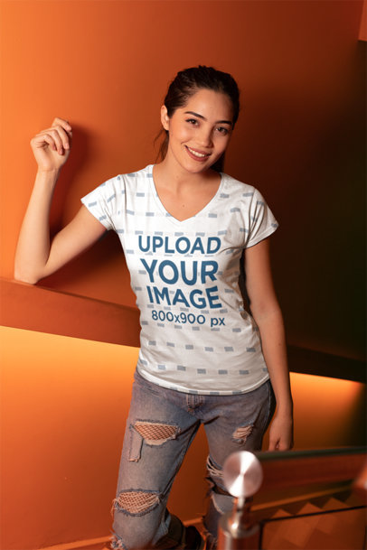 V-Neck T-Shirt Mockup of a Woman Leaning over a Wall