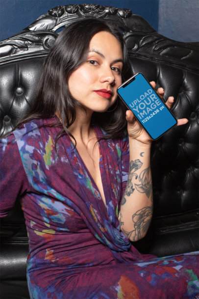 iPhone XS Mockup Featuring a Woman Sitting on a Leather Sofa 25375