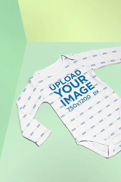Mockup of a Sublimated Onesie Lying on a Split Colored Background