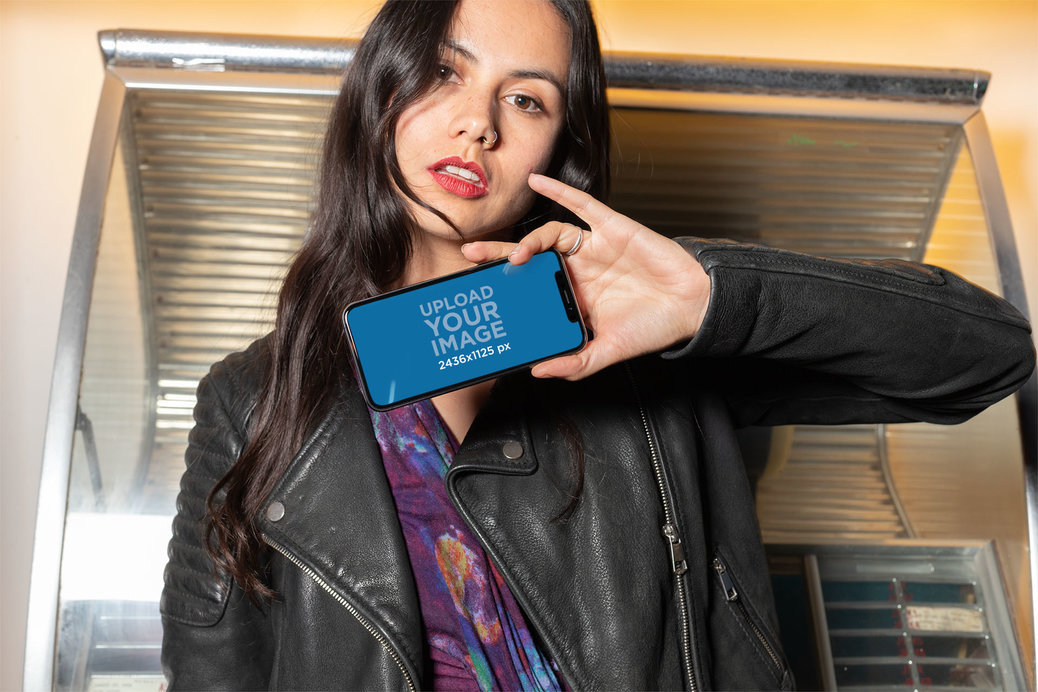 Mockup of an Edgy Woman Showing the Screen of Her iPhone 11 Pro