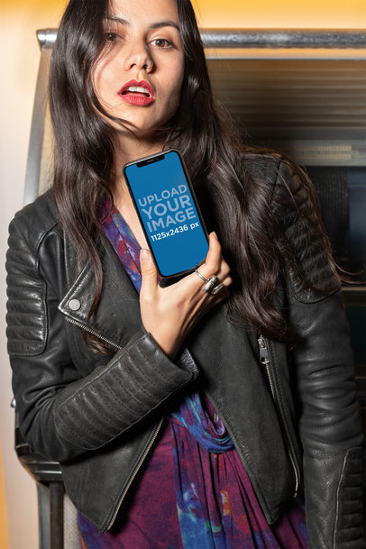 Mockup of a Rocker Girl Holding an iPhone XS Against Her Chest 25382