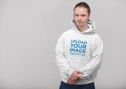 Pullover Hoodie Mockup of a Blonde Man with Tied Hair Holding His Arm