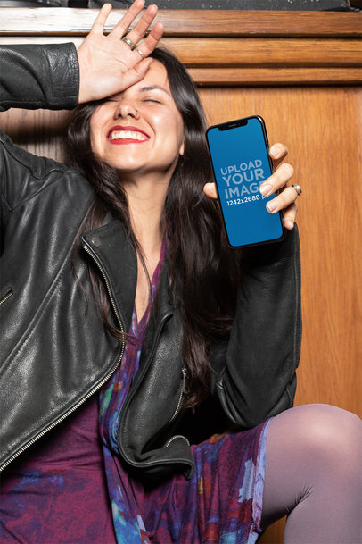 Mockup of a Woman Holding Her iPhone 11 Pro Max While Making a Funny Pose