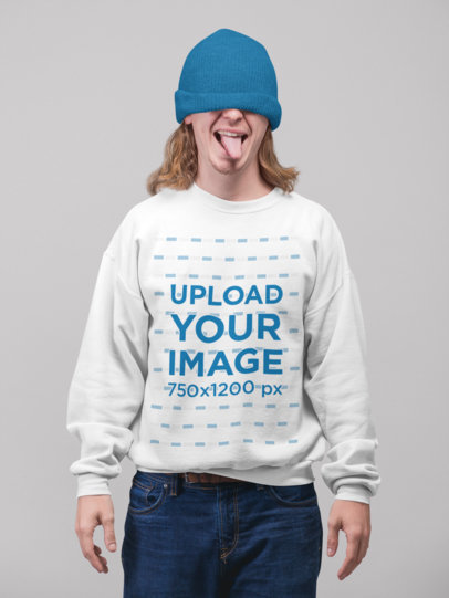Sweatshirt Mockup of a Man Covering His Eyes with a Beanie and Showing His Tongue