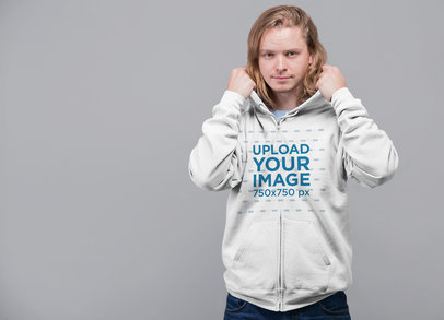 Mockup Featuring a Long-Haired Man Putting on His Full-Zip Hoodie