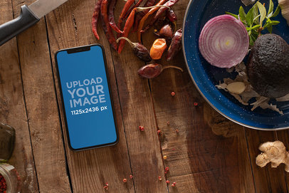 Mockup of an iPhone XS Surrounded by Vegetables 25391