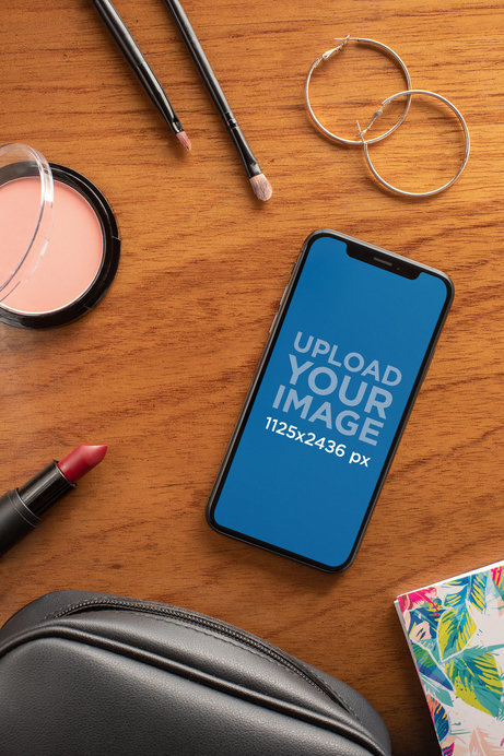 Mockup of an iPhone 11 Pro Lying on a Table with Makeup Tools